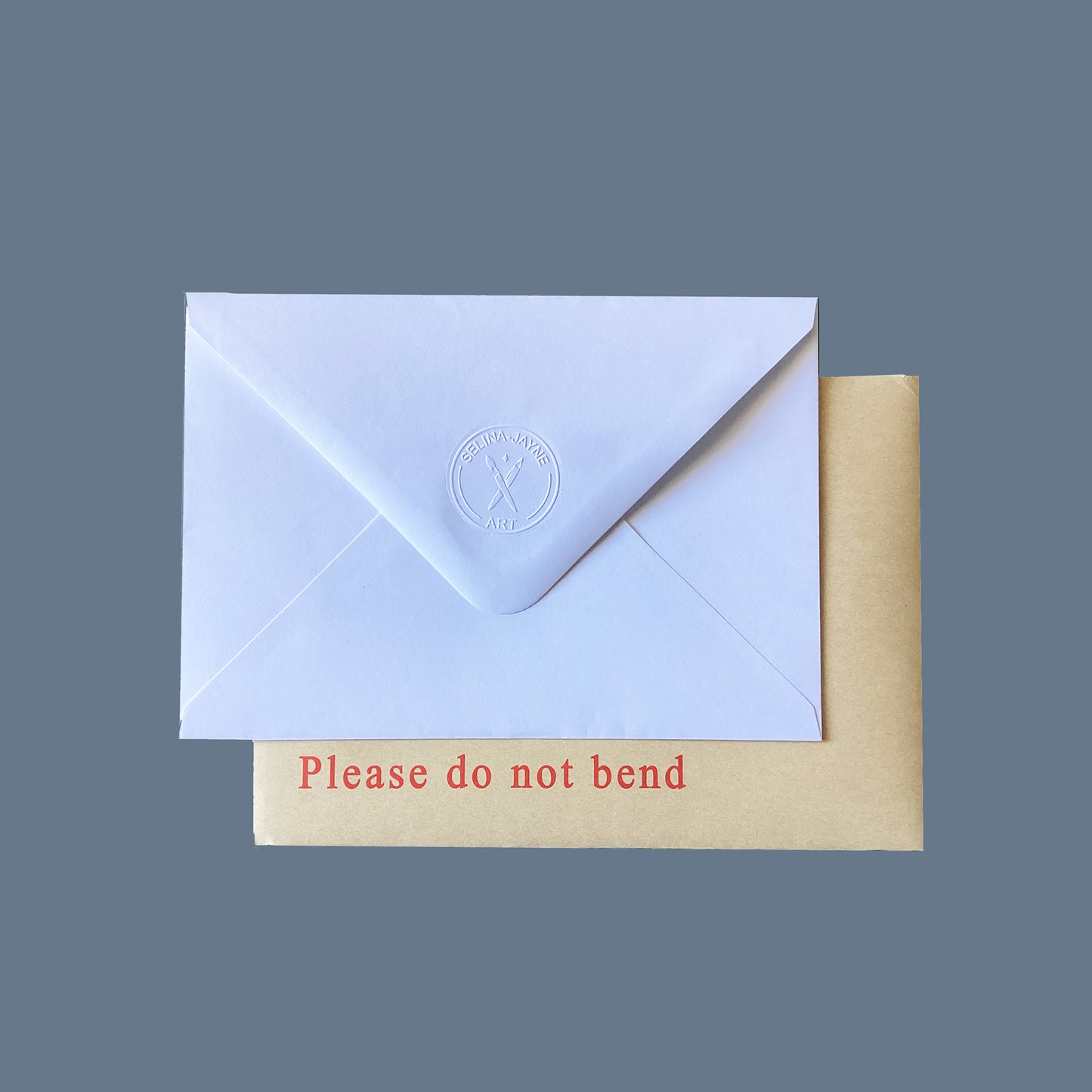 White envelope with a Selina-Jayne Art stamp on flap