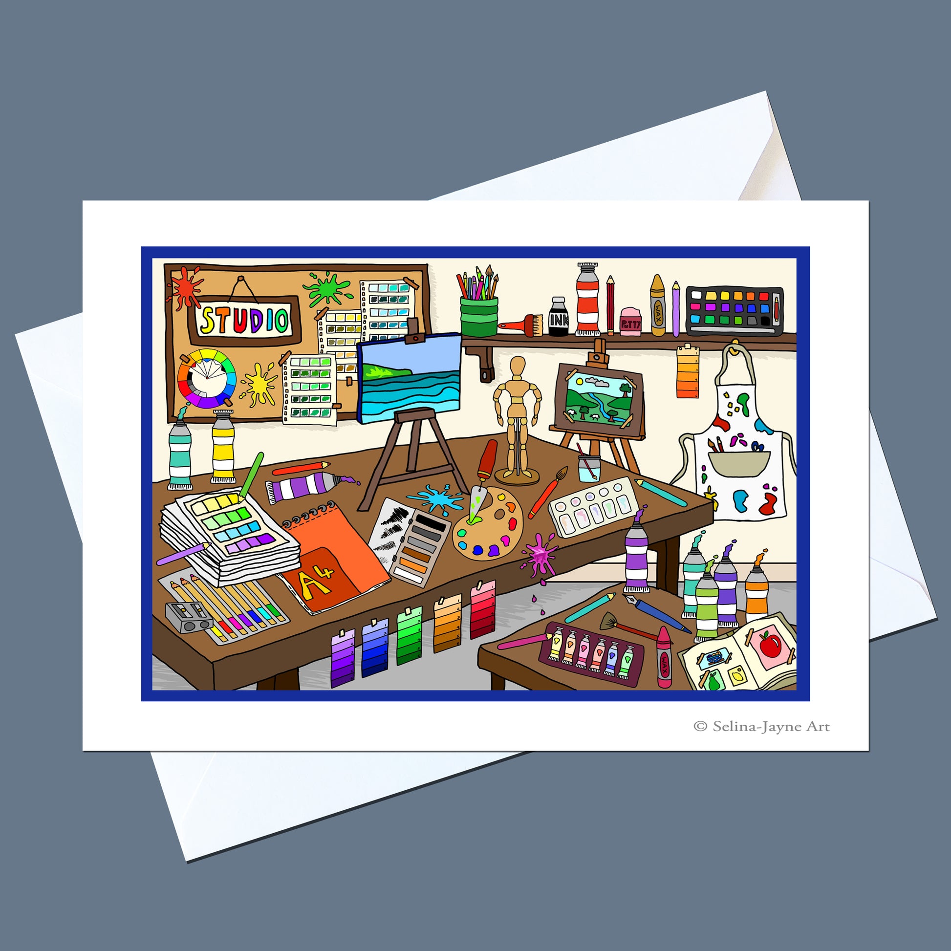 A white art print card featuring a colorful cartoon illustration of a creative artist studio, shown with a white envelope on a slate gray background. The print includes the text '© Selina Jayne Art' in the bottom right corner.
