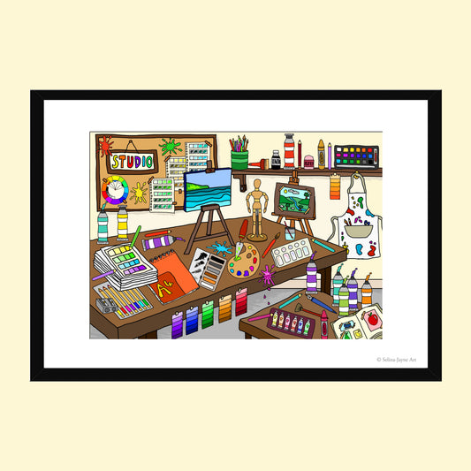A framed cartoon art studio illustration featuring colorful paint tubes, easels, canvases, brushes, shelves, and an artist's worktable, presented on a light cream background with a black frame.