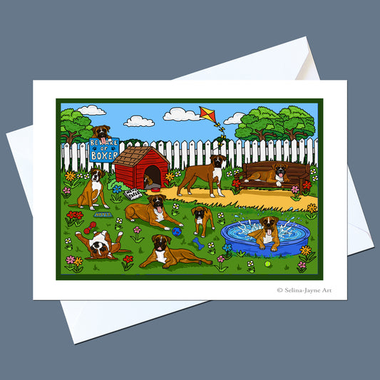 A white art print card featuring a colorful cartoon illustration of several Boxer dogs in a backyard with a dog house, fence, trees, and pool, shown with an envelope on a gray background.
