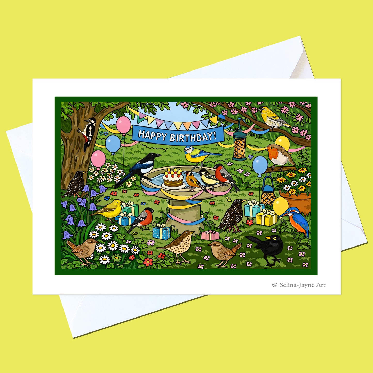 A square birthday greeting card with a white border and white envelope, featuring a colorful illustrated scene of birds, flowers, balloons, and a birthday cake with the text 'HAPPY BIRTHDAY!'.