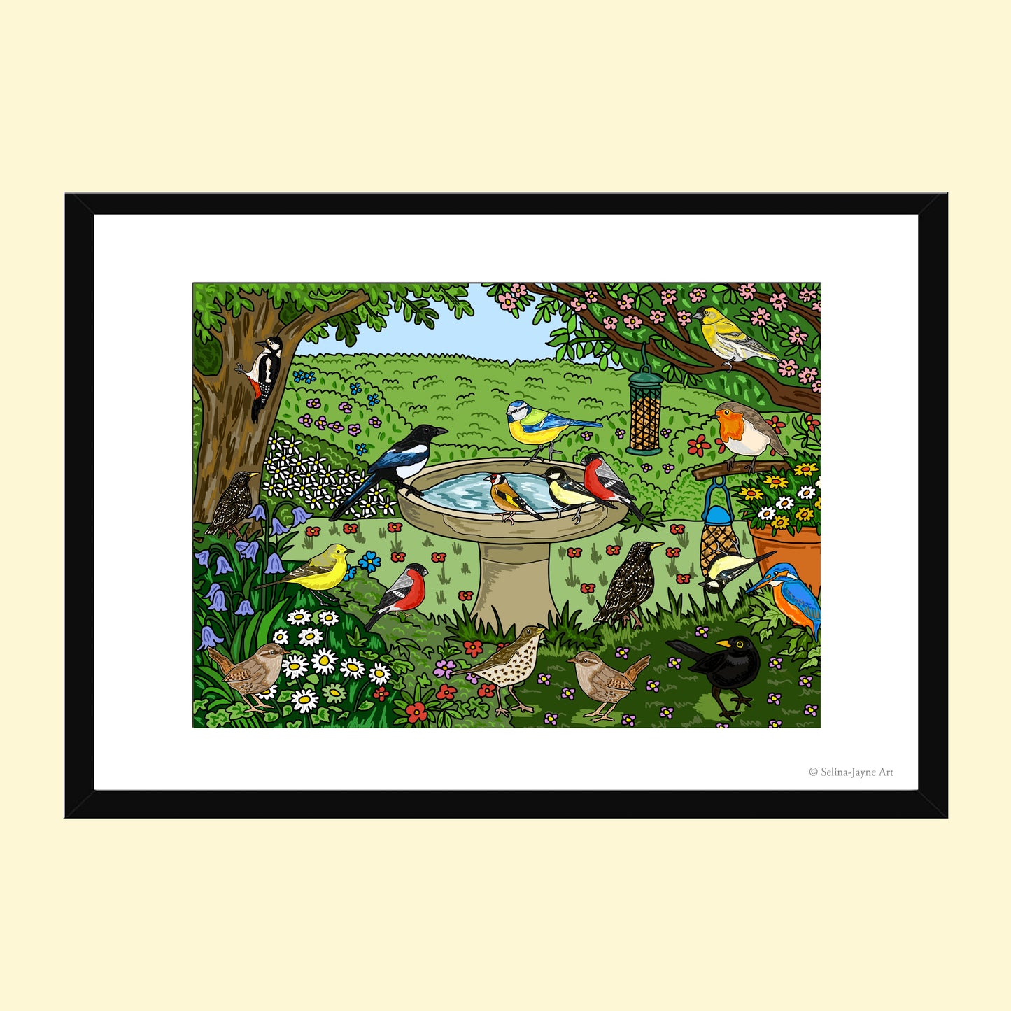 A framed art print featuring a colorful illustration of various birds in a lush garden scene with a birdbath, trees, and flowers, presented on a light cream background.