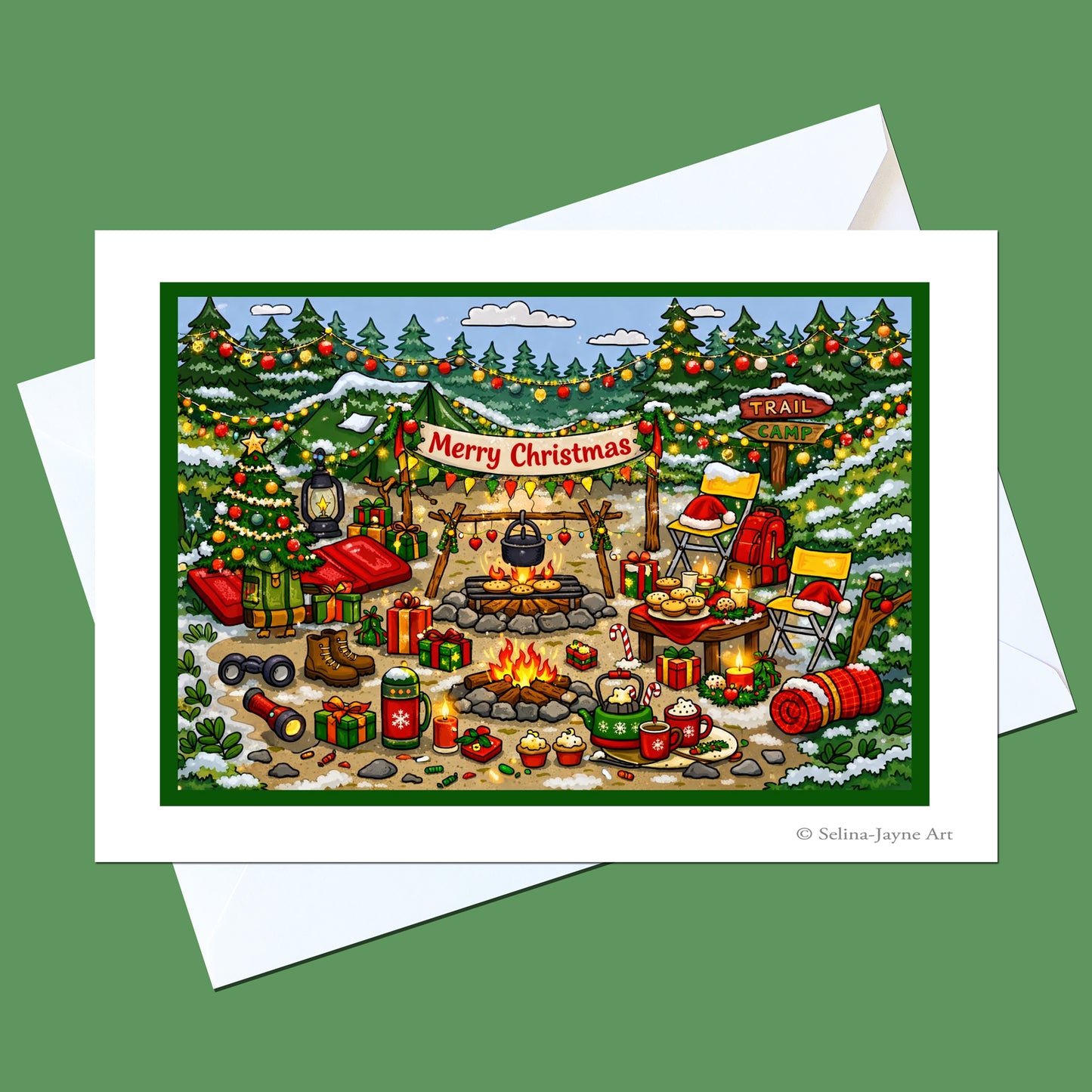 A square Christmas art print or greeting card shown on a green background with white envelopes behind it. The illustrated scene depicts a festive winter campsite with snow-covered trees, a campfire, gifts, lanterns, and a banner reading “Merry Christmas.
