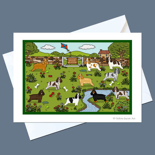 A square greeting card featuring a colorful cartoon illustration of various dog breeds in a park, displayed on top of two white envelopes against a slate blue-gray background.