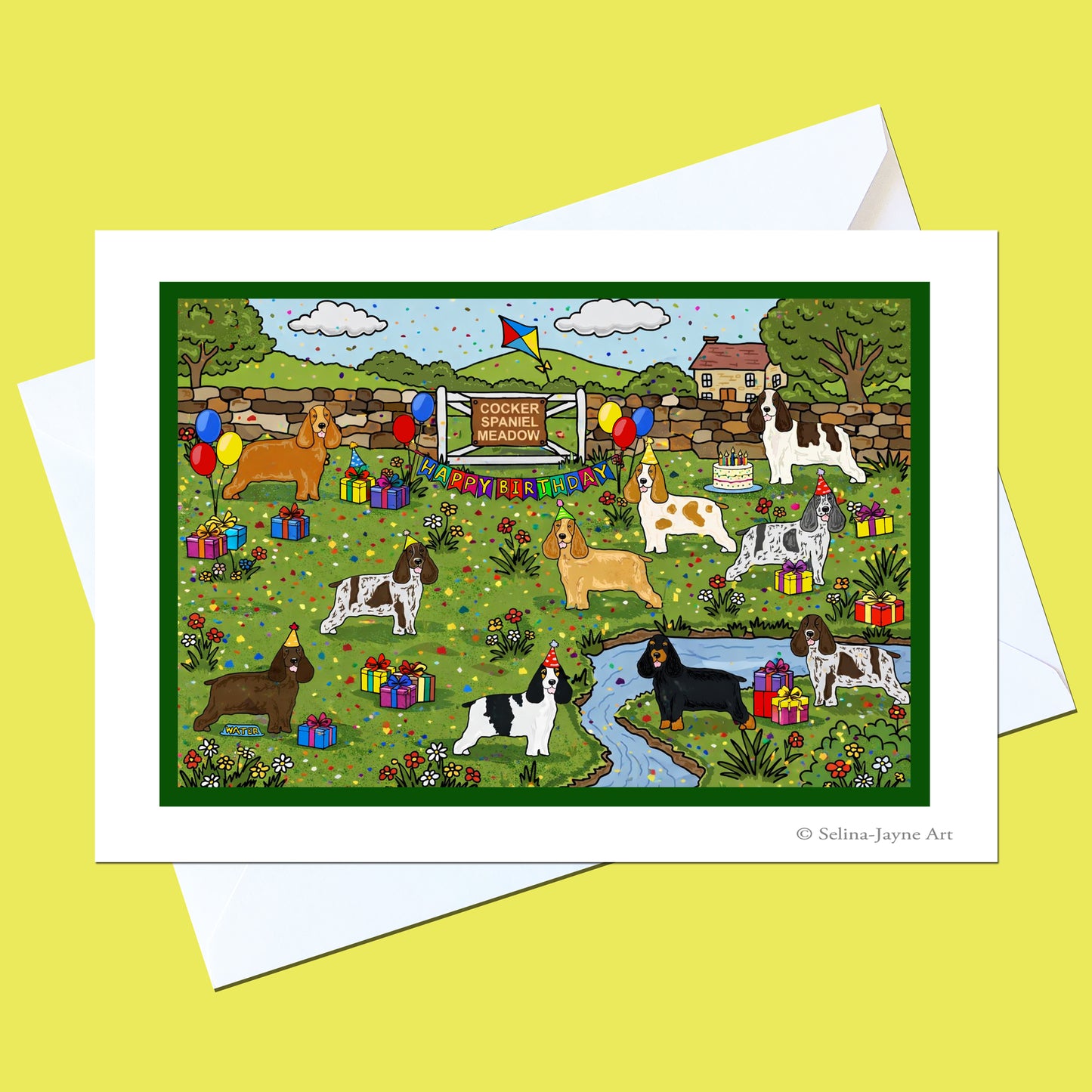 A square art print or card featuring a colorful illustrated scene of various dog breeds gathered outdoors near a stream, with balloons, gifts, a sign reading 'Cocker Spaniel Meadow', and a banner that says 'May 1st Birthday'. The print is shown with white envelopes on a solid pale yellow background.