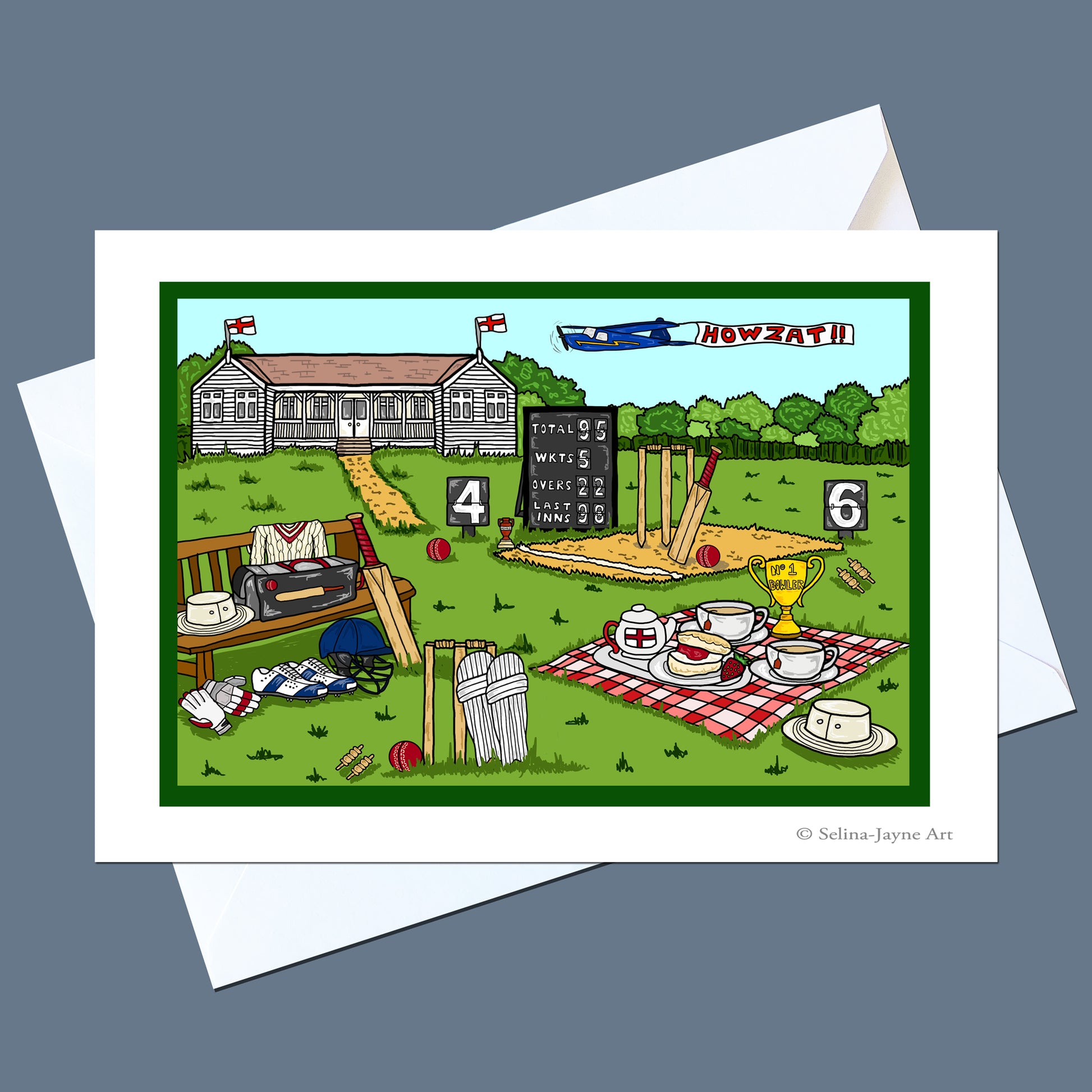 A white greeting card with a colorful cartoon illustration of a cricket match scene, shown with white envelopes on a dark gray background. The illustration includes a cricket pitch, scoreboard, bench, tea set, and a building labeled 'HOWZATH'.