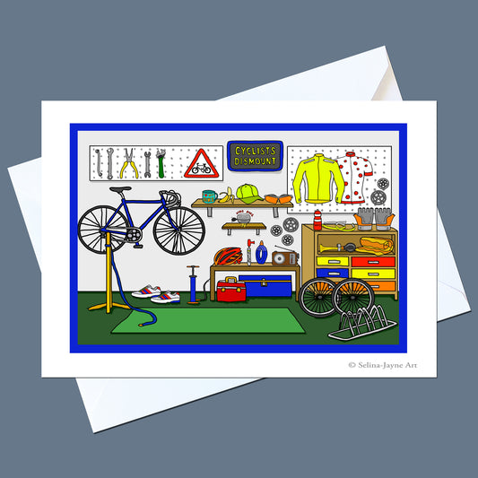 A square art print or greeting card featuring a colorful cartoon bicycle workshop scene, shown with white envelopes on a muted blue-gray background. The illustration includes a blue bicycle on a stand, tools on a wall, a yellow jersey, shelves, and storage cabinets.