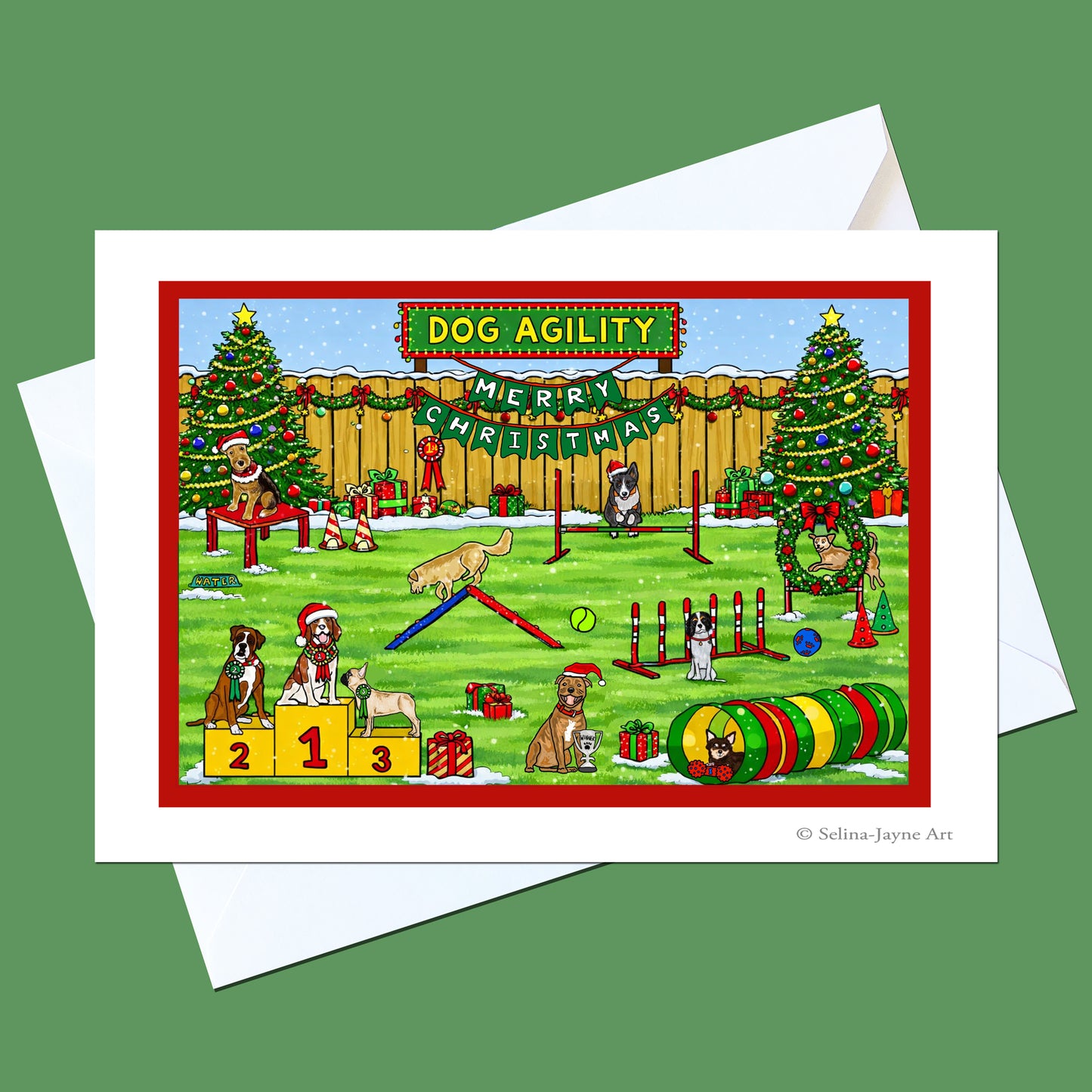 A Christmas-themed dog agility greeting card with a white envelope behind it, set against a solid green background. The card features a colorful cartoon illustration of dogs participating in dog agility tricks in a snowy yard decorated with Christmas trees and a 'Merry Christmas' banner.