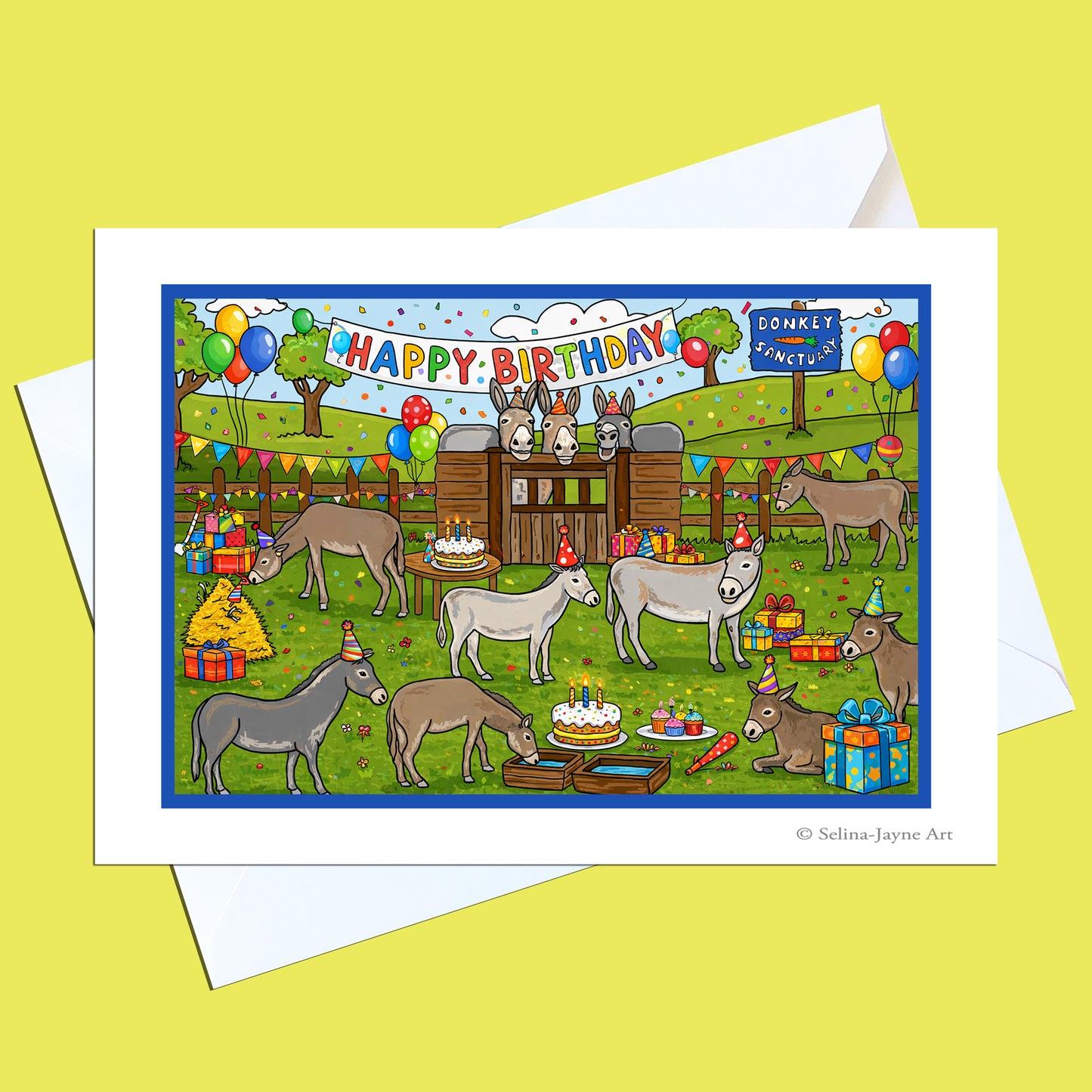 A birthday greeting card with a white envelope, featuring a colorful cartoon illustration of donkeys celebrating with balloons, cakes, gifts, and a banner that reads 'HAPPY BIRTHDAY'.