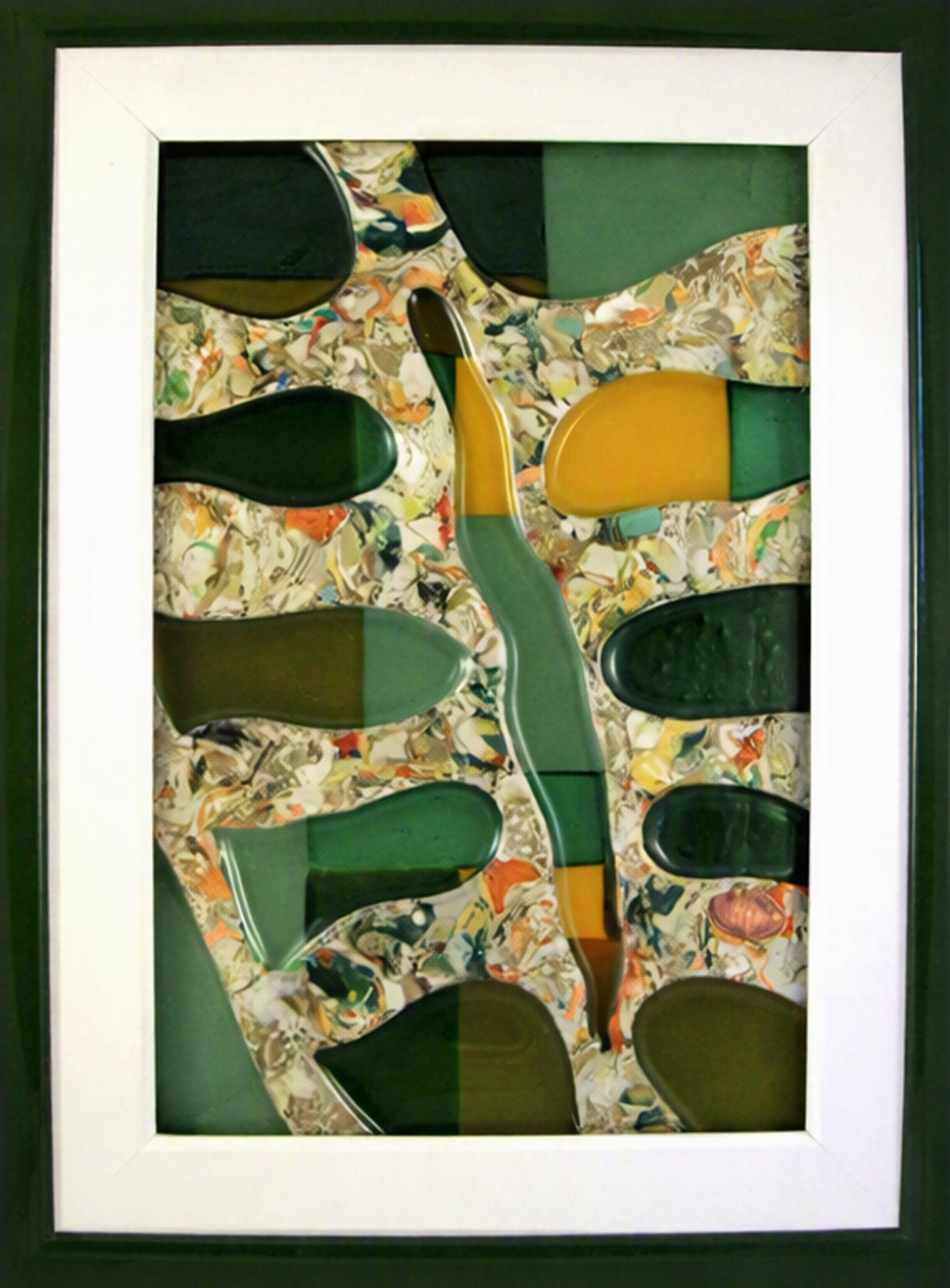 Framed Trapunto Art Glass featuring organic shapes in dark green, mustard yellow, and olive tones over a multicoloured marbled background, presented in a white mat and dark frame.
