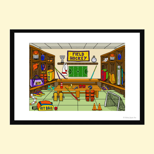 A framed cartoon art print titled 'FIELD HOCKEY' showing a humorous locker room scene filled with sports equipment, presented on a light cream background.