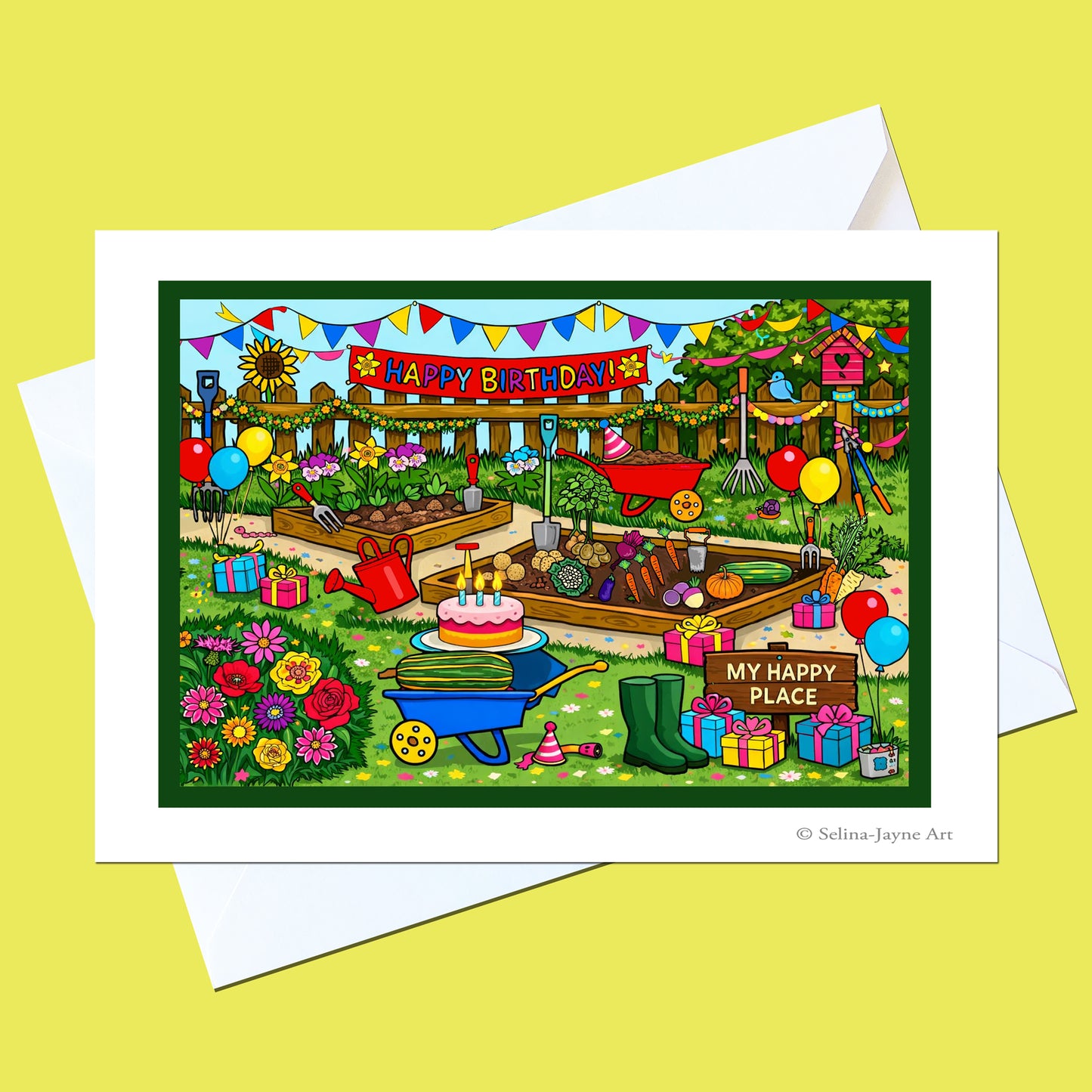 A colorful birthday garden art print on a white card with a white envelope, displayed on a solid pale yellow background. The illustration features a busy garden scene with a birthday cake, balloons, flowers, and a 'HAPPY BIRTHDAY' banner.
