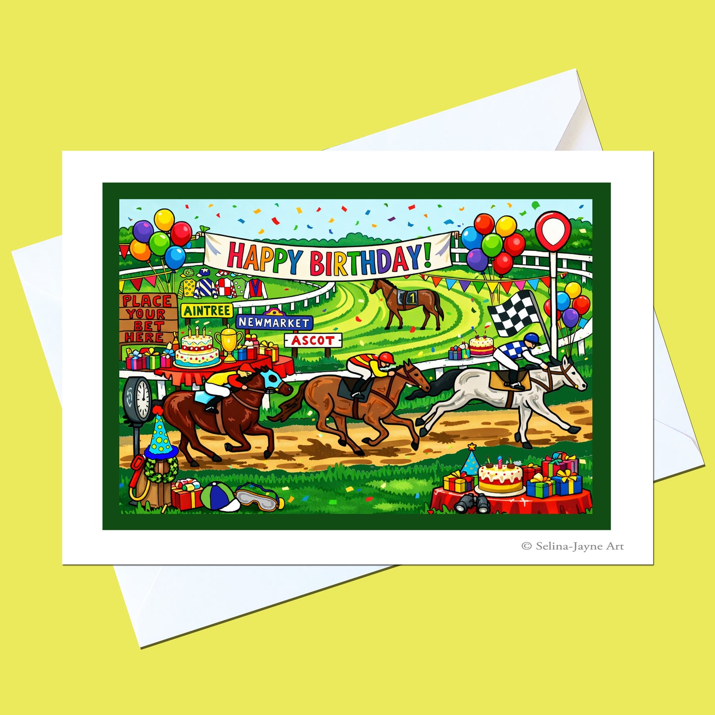 A colorful birthday racehorse illustration printed on a white greeting card, with a white envelope behind it on a pale yellow background. The artwork shows horse racers at a racecourse with balloons, cakes, and a 'HAPPY BIRTHDAY!' banner.