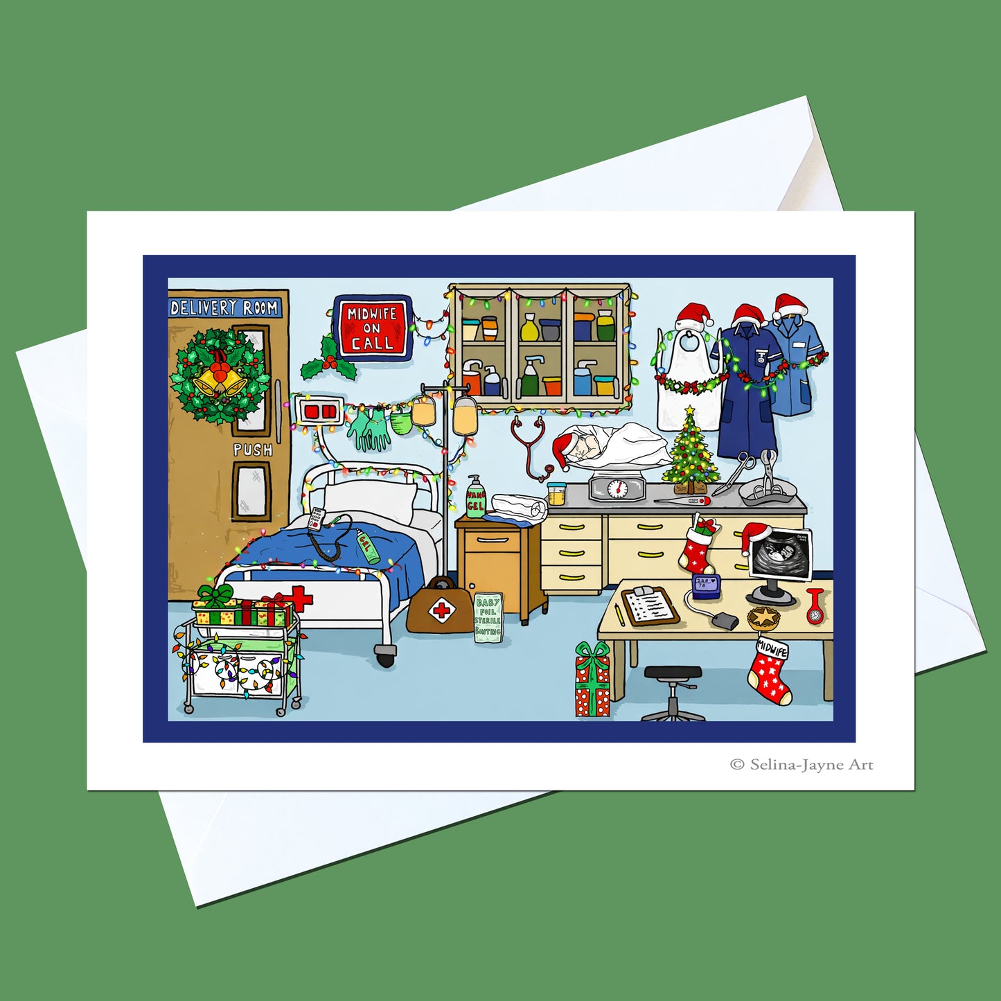 A square art print or card featuring a detailed holiday hospital room illustration, shown with white envelopes on a solid green background. The artwork has a dark blue border and includes medical staff in Santa hats, Christmas decorations, a bed, and medical equipment.