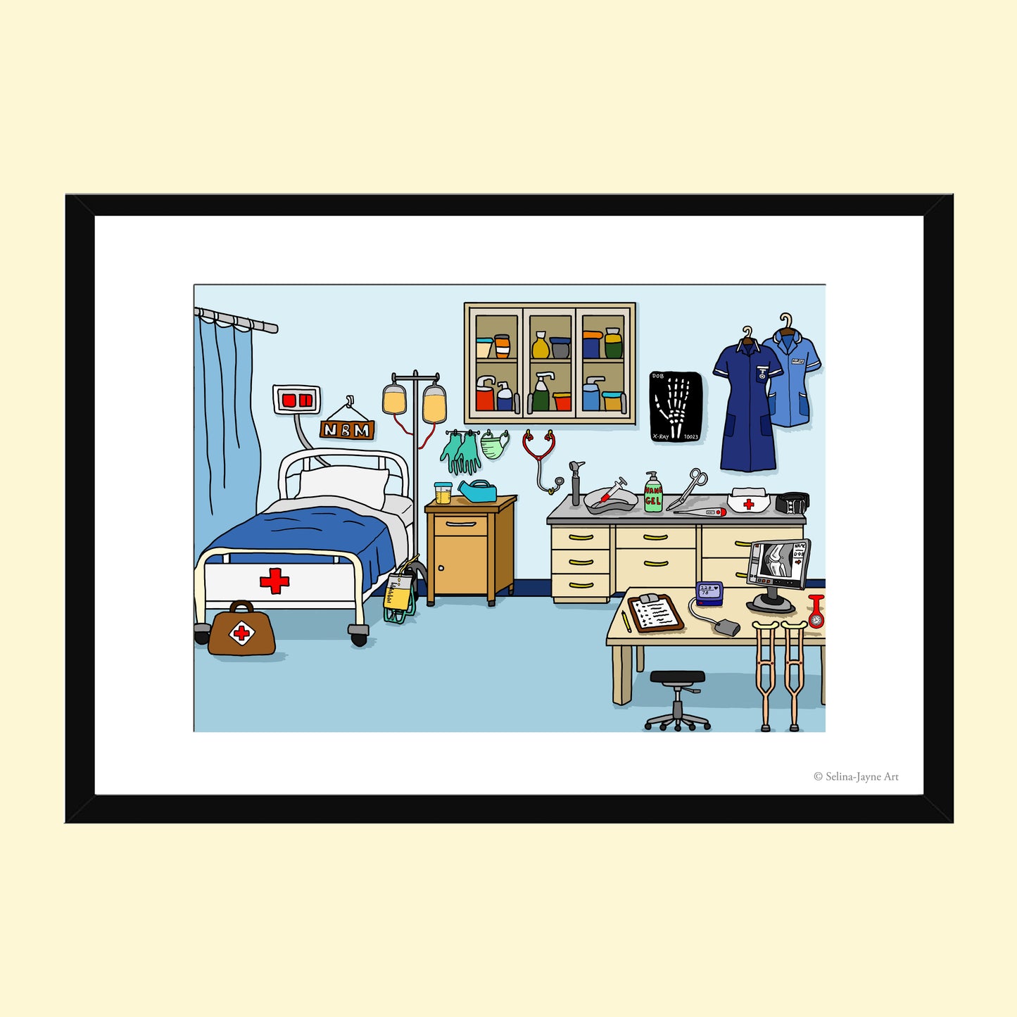 A framed medical room illustration print featuring a hospital bed, examination table, medical equipment, and uniforms, shown with a black frame and white mat on a pale yellow background.