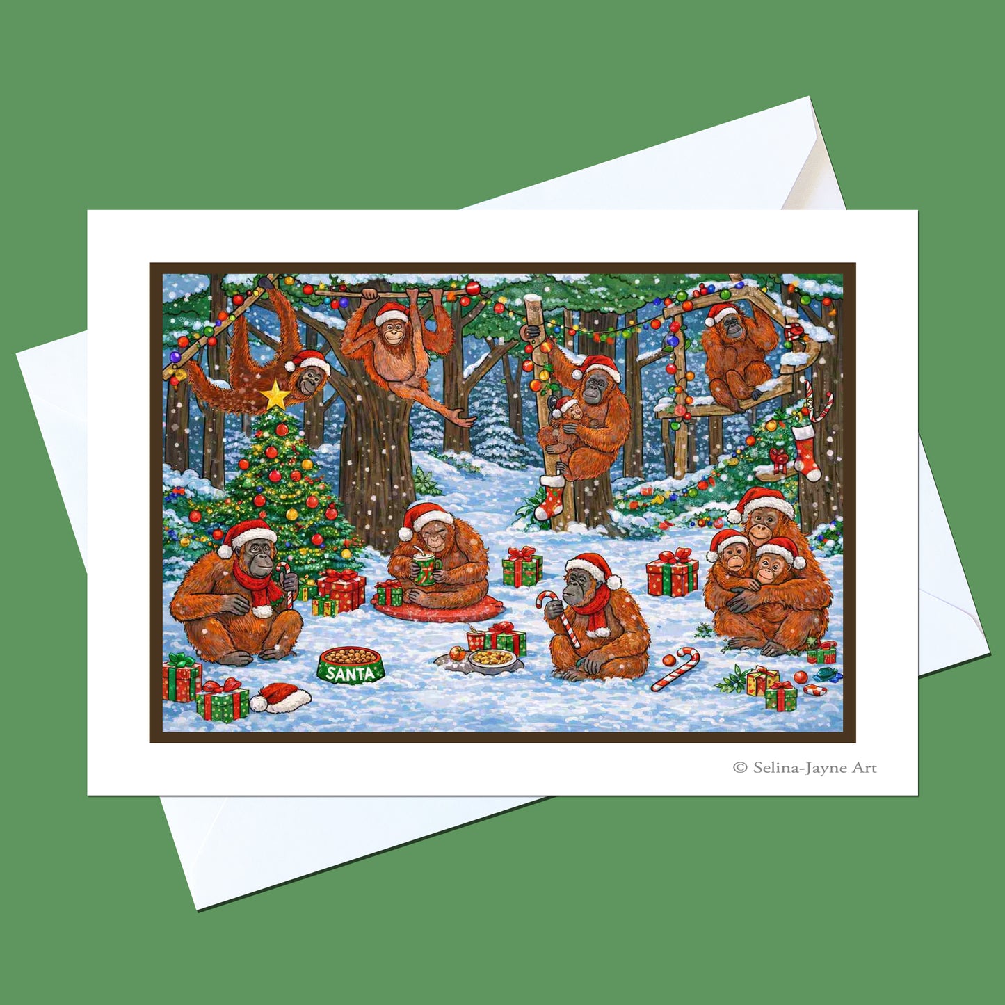 A Christmas-themed art print card featuring cartoon bears in a snowy forest decorated with ornaments and gifts, shown with a white envelope on a solid green background.