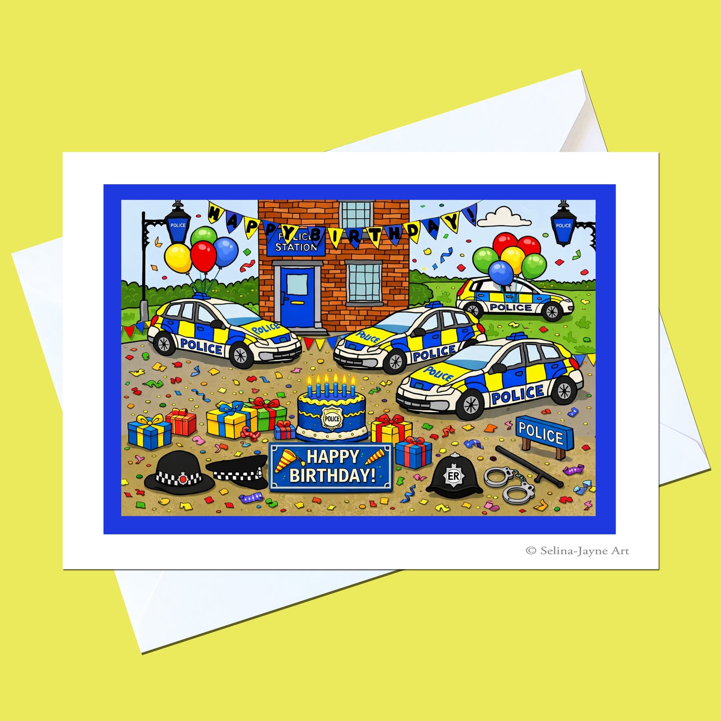 A birthday greeting card featuring a colorful cartoon illustration of a police station birthday party with police cars, balloons, presents, and a cake, shown with white envelopes on a yellow background.