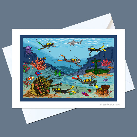 A square art print or card featuring a colorful underwater scene with divers, a shark, coral, a sunken ship, and a treasure chest, shown with white envelopes on a gray background. Small text at the bottom right reads '© Selina Jayne Art'.