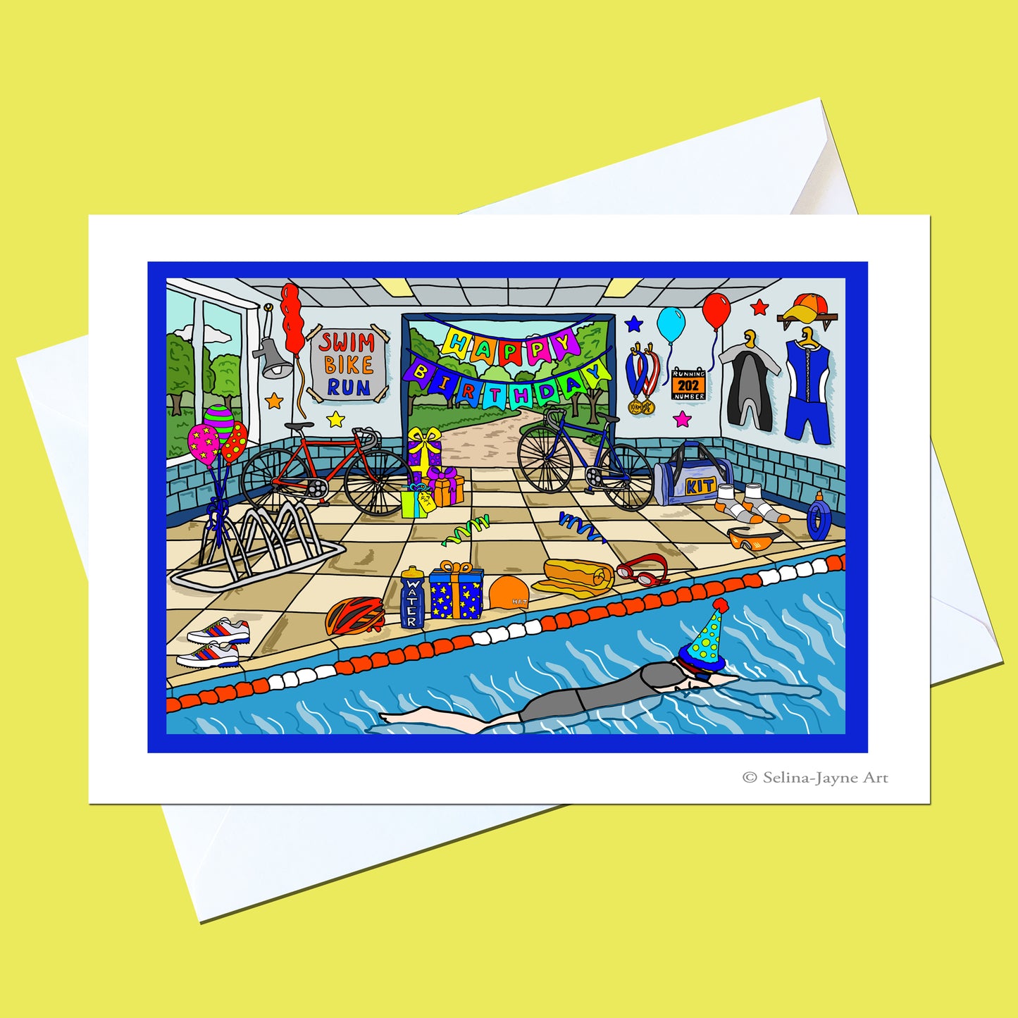 A square art print or card featuring a colorful cartoon illustration of a swim and bike party scene, shown with white envelopes on a pale yellow background. The artwork includes a pool, bicycles, balloons, clothing, and banners reading 'Swim Bike Run' and 'Happy Birthday'.