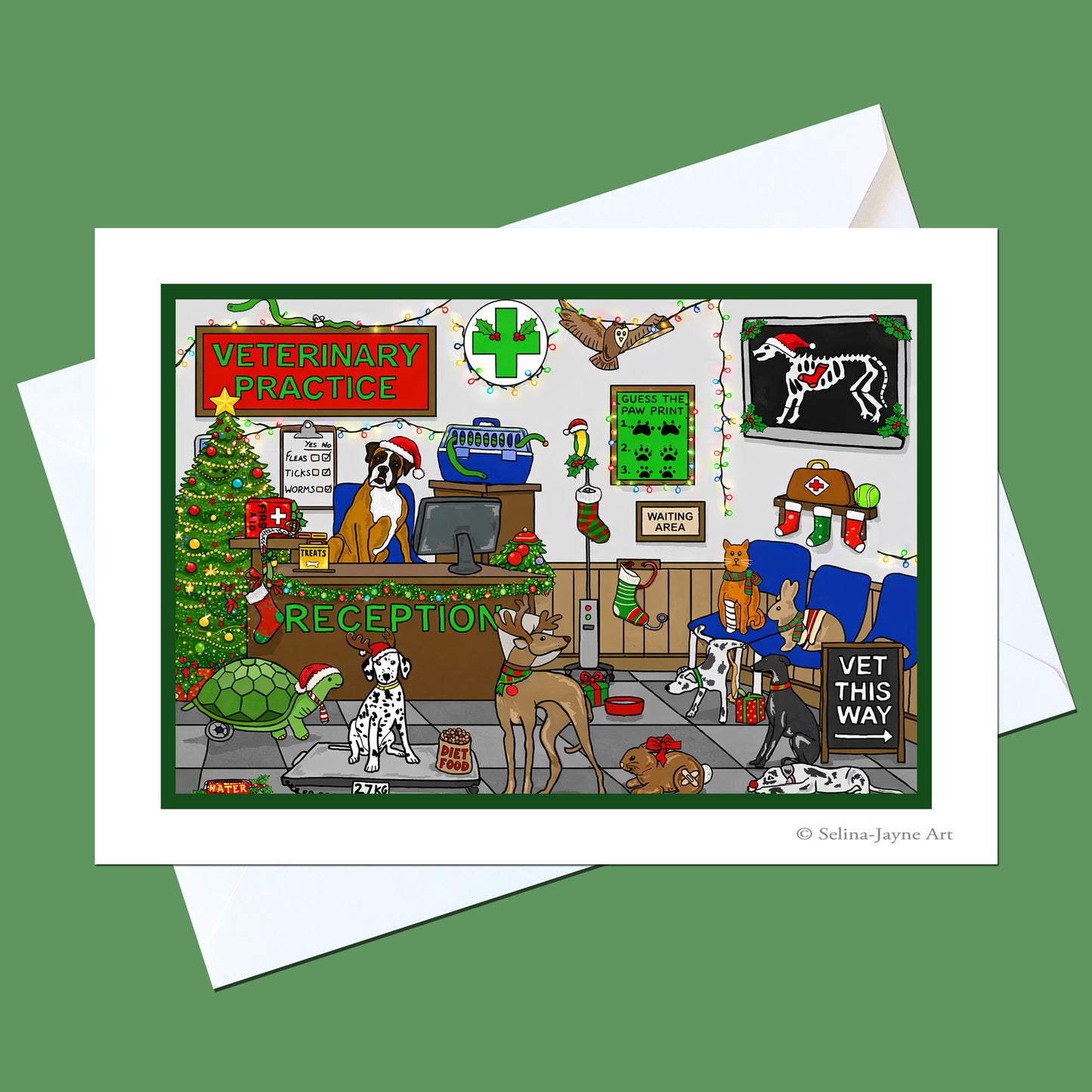 A square art print with a white border showing a whimsical cartoon veterinary practice scene decorated for Christmas, displayed on top of white envelopes against a solid green background. The print includes illustrated pets, staff, a Christmas tree, and holiday signs.